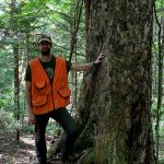 Eric standing by tree